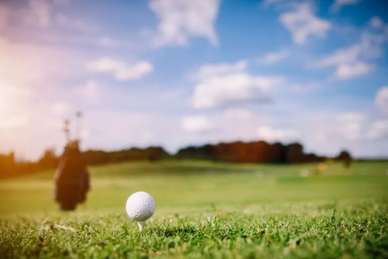 White golf ball on a green grass