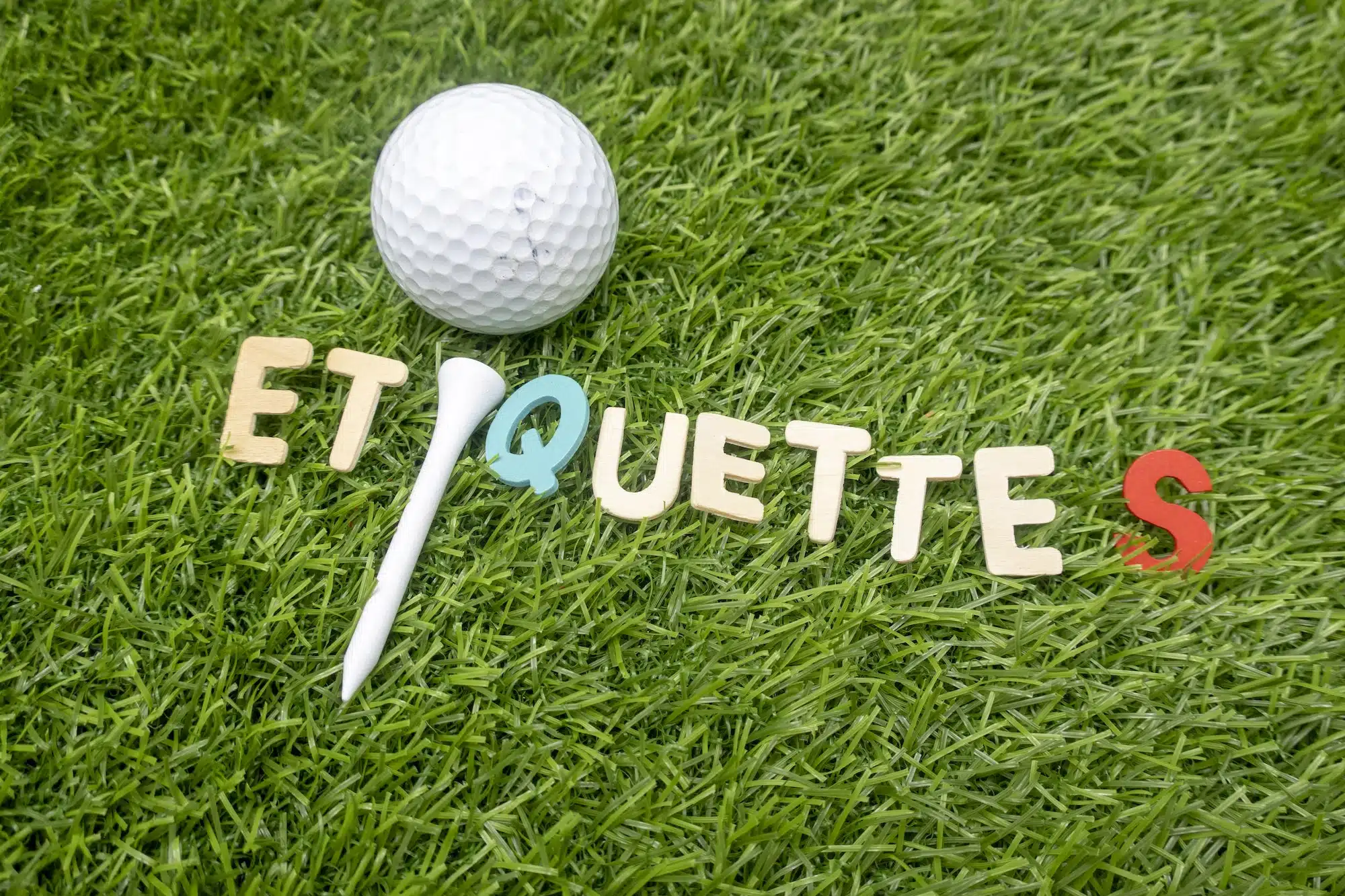 etiquette word on green grass with golf ball